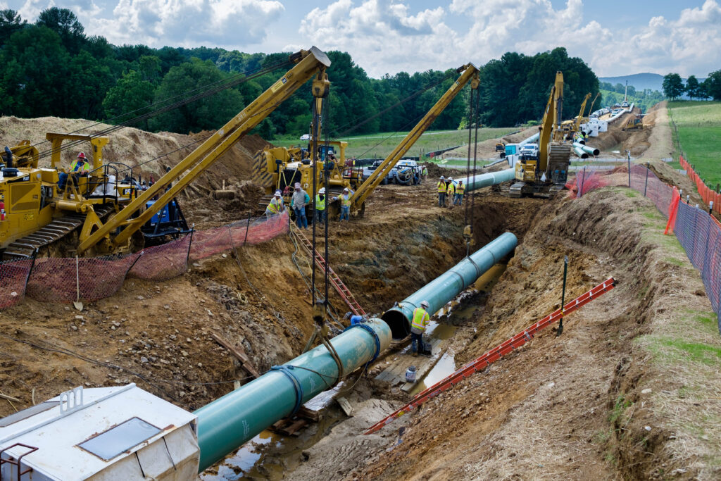 Workers laying the Mountain Valley Pipeline in Roanoke County. (Ned Oliver / Virginia Mercury)